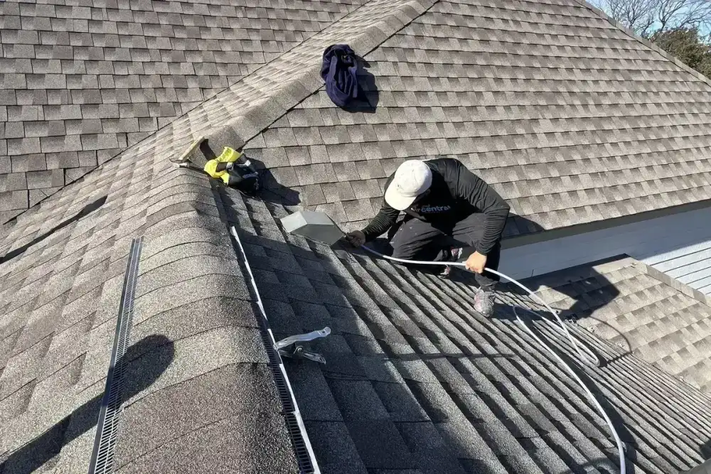 Technician cleaning rooftop dryer vent at Austin home