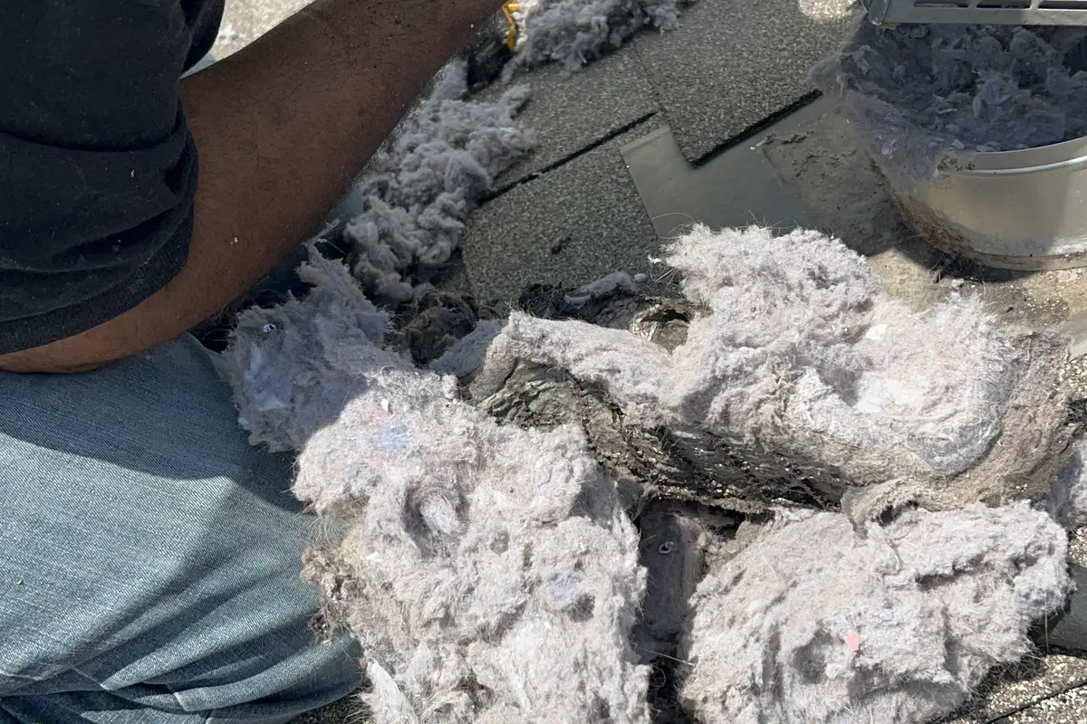 Signs 6 and 7: Hot Laundry Room and Visible Lint Accumulation - Air Central dryer vent service in Austin TX