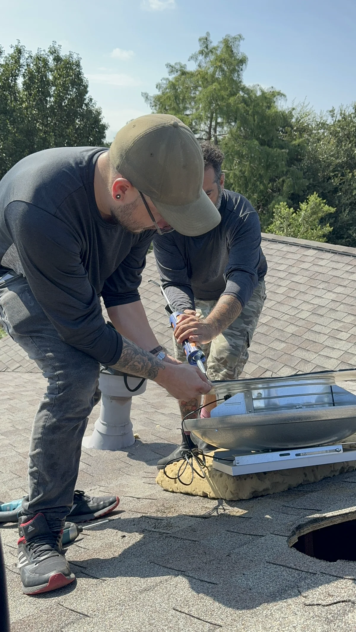 Solar attic fan installed on Austin home roof with solar panel visible