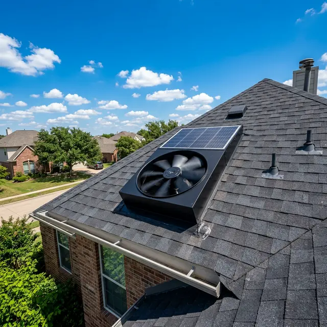 Solar-powered fan ventilating attic space on Austin TX residential roof